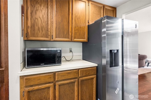 8113 S 121st St, Seattle, WA 98178 - kitchen featuring appliances with stainless steel finishes, light countertops, wood finished floors, and brown cabinets