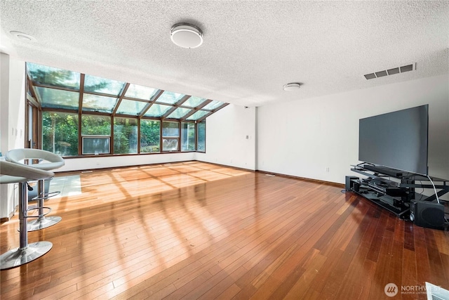 8113 S 121st St, Seattle, WA 98178 - unfurnished living room with a textured ceiling and hardwood / wood-style floors