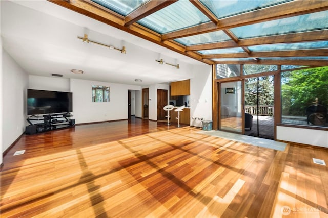 8113 S 121st St, Seattle, WA 98178 - unfurnished living room featuring wood finished floors and a skylight