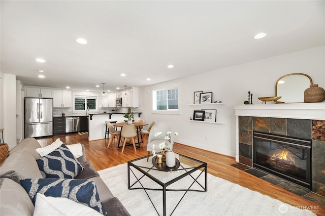 9217 Roosevelt Way NE Unit B, Seattle, WA 98115 - living room with recessed lighting, a tile fireplace, and wood finished floors