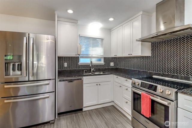 7718 50th Ave E, Tacoma, WA 98443 - kitchen featuring stainless steel appliances, exhaust hood, dark countertops, white cabinets, and backsplash