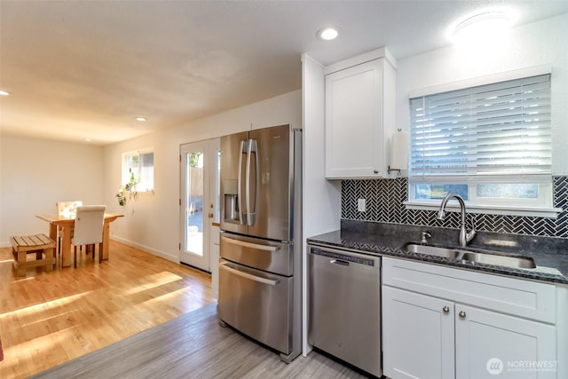 7718 50th Ave E, Tacoma, WA 98443 - kitchen with appliances with stainless steel finishes, white cabinets, light wood finished floors, decorative backsplash, and recessed lighting
