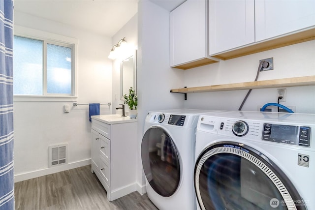 7718 50th Ave E, Tacoma, WA 98443 - laundry area featuring washing machine and dryer and light wood-style floors