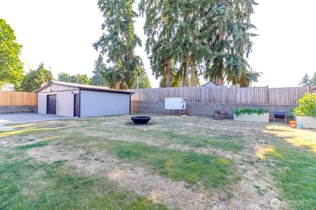 7718 50th Ave E, Tacoma, WA 98443 - fenced backyard with an outdoor fire pit and an outdoor structure