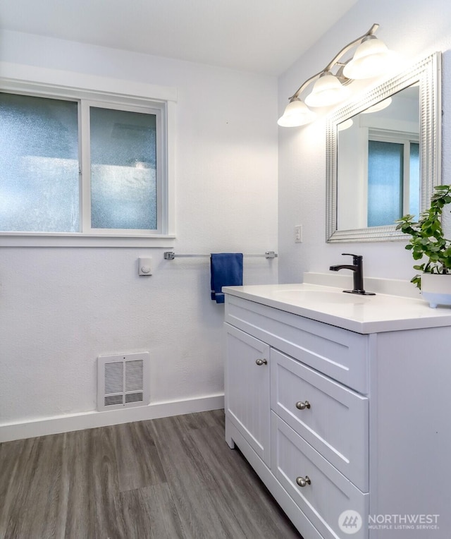 7718 50th Ave E, Tacoma, WA 98443 - bathroom featuring vanity and wood finished floors