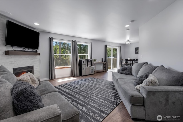 19826 207th Street Ct E, Orting, WA 98360 - living room featuring plenty of natural light, a fireplace, wood finished floors, and recessed lighting