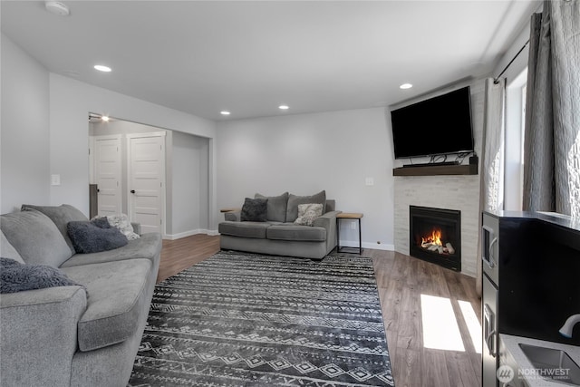 19826 207th Street Ct E, Orting, WA 98360 - living area featuring wood finished floors, a fireplace, and recessed lighting
