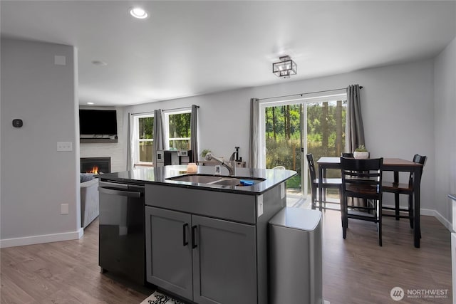 19826 207th Street Ct E, Orting, WA 98360 - kitchen featuring dishwashing machine, dark countertops, gray cabinetry, a fireplace, and open floor plan
