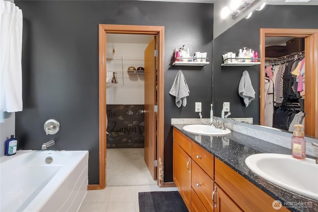 19826 207th Street Ct E, Orting, WA 98360 - bathroom with double vanity, a walk in closet, a bath, and tile patterned flooring
