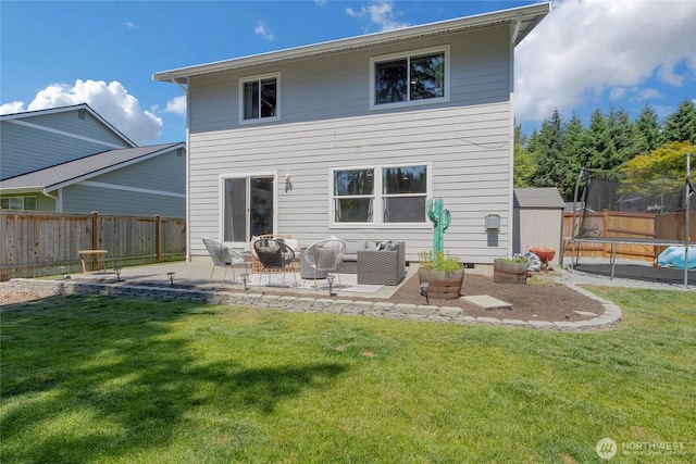 19826 207th Street Ct E, Orting, WA 98360 - rear view of house featuring a trampoline, a patio, a fenced backyard, a shed, and an outdoor living space