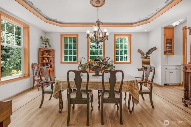 19808 Yew Way, Snohomish, WA 98296 - dining area with a chandelier, light wood-type flooring, a raised ceiling, and plenty of natural light