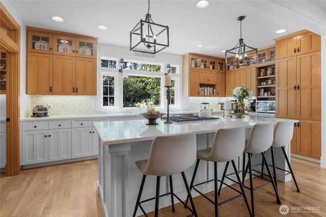 19808 Yew Way, Snohomish, WA 98296 - kitchen featuring light countertops, a kitchen island, appliances with stainless steel finishes, decorative backsplash, and recessed lighting