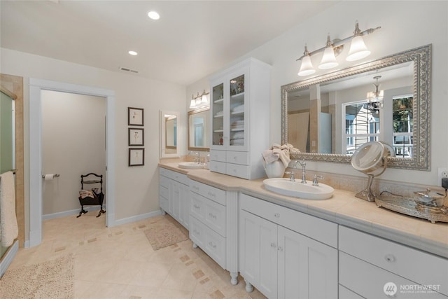 19808 Yew Way, Snohomish, WA 98296 - full bathroom with double vanity, a shower stall, a chandelier, recessed lighting, and tile patterned floors