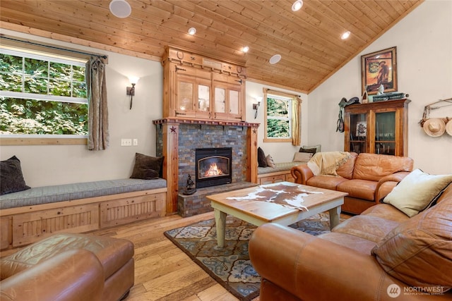 19808 Yew Way, Snohomish, WA 98296 - living room featuring vaulted ceiling, wooden ceiling, light wood-style flooring, recessed lighting, and a stone fireplace
