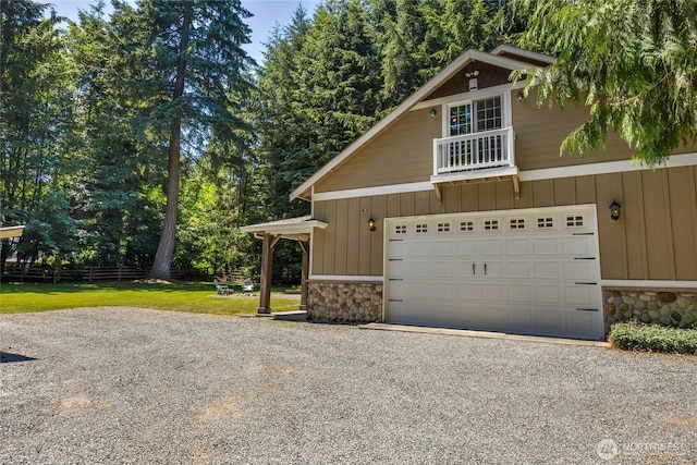 19808 Yew Way, Snohomish, WA 98296 - view of front of house featuring stone siding, board and batten siding, a balcony, driveway, and a front lawn