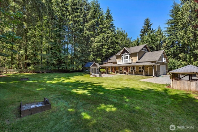19808 Yew Way, Snohomish, WA 98296 - view of green lawn featuring a garage, driveway, and a porch
