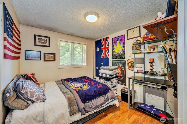 17141 SE 267th St, Covington, WA 98042 - bedroom featuring wood finished floors and a textured ceiling