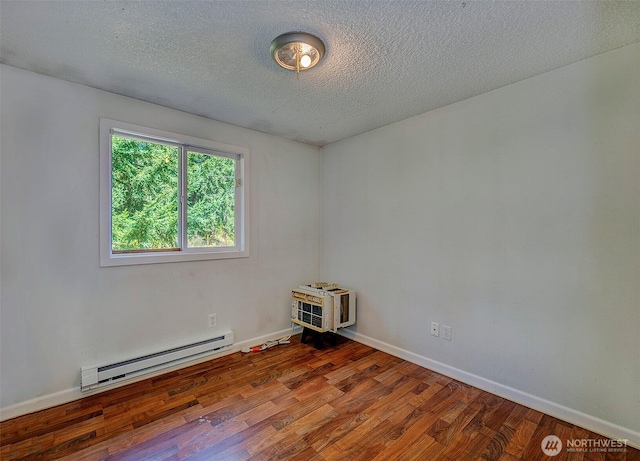 17141 SE 267th St, Covington, WA 98042 - spare room featuring baseboard heating, wood finished floors, and a textured ceiling