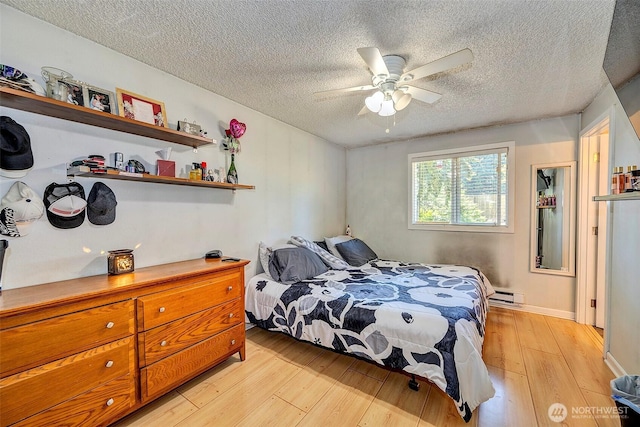 17141 SE 267th St, Covington, WA 98042 - bedroom with light wood finished floors, a textured ceiling, baseboard heating, and ceiling fan