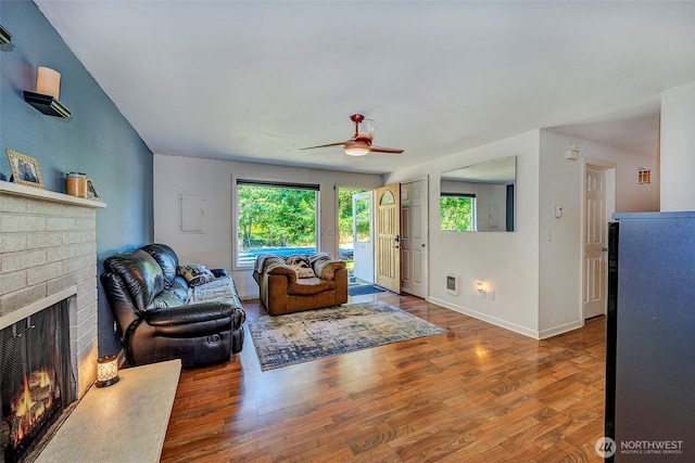 17141 SE 267th St, Covington, WA 98042 - living area with a brick fireplace, wood finished floors, and ceiling fan
