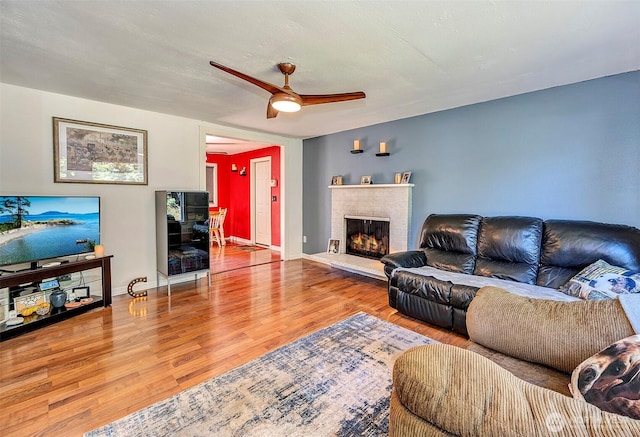17141 SE 267th St, Covington, WA 98042 - living area featuring wood finished floors, a brick fireplace, and ceiling fan