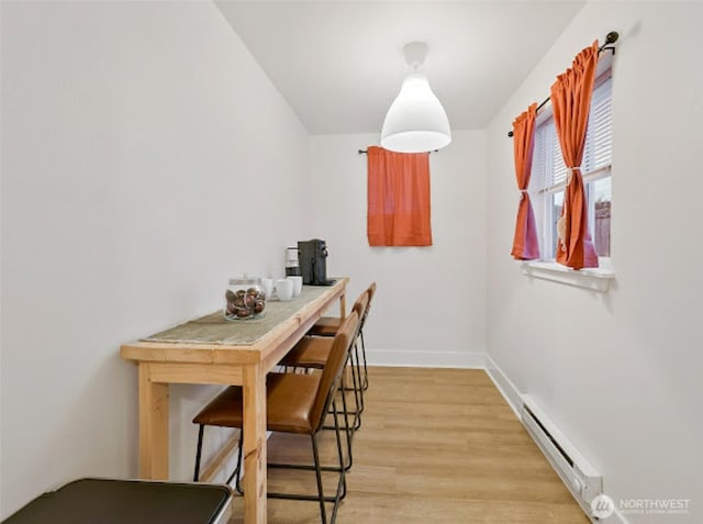 2118 S Sheridan Ave, Tacoma, WA 98405 - dining space with a baseboard heating unit and light wood-style floors