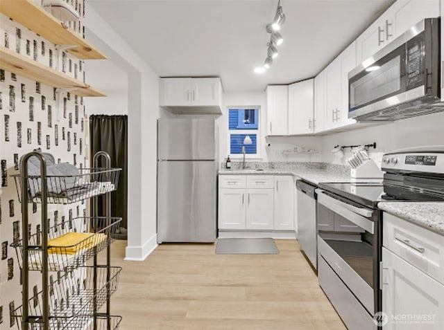 2118 S Sheridan Ave, Tacoma, WA 98405 - kitchen featuring stainless steel appliances, open shelves, white cabinetry, and light stone countertops