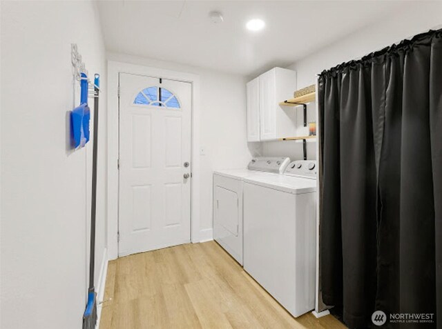 2118 S Sheridan Ave, Tacoma, WA 98405 - laundry room featuring washer and clothes dryer, light wood-style flooring, and cabinet space