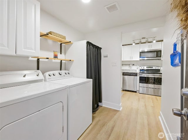 2118 S Sheridan Ave, Tacoma, WA 98405 - washroom featuring washing machine and clothes dryer and light wood-style floors