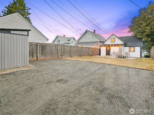 2118 S Sheridan Ave, Tacoma, WA 98405 - yard at dusk with a fenced backyard and a shed