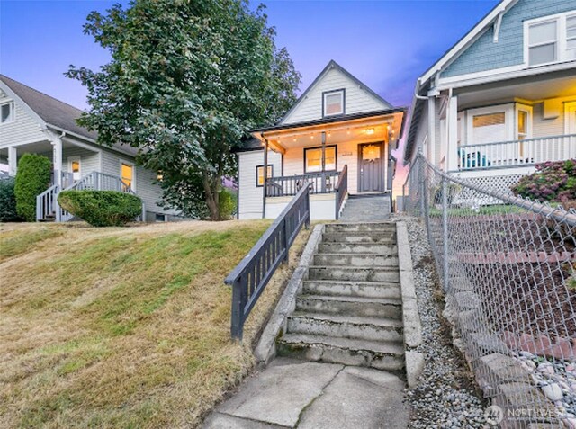 2118 S Sheridan Ave, Tacoma, WA 98405 - view of front of house with stairway, a porch, and a front yard