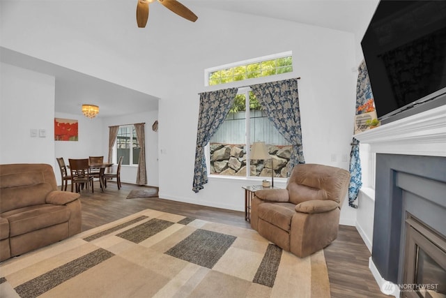 19168 110th Pl SE Unit 19168, Renton, WA 98055 - living area featuring wood finished floors, a fireplace, plenty of natural light, a ceiling fan, and high vaulted ceiling
