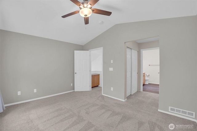 19168 110th Pl SE Unit 19168, Renton, WA 98055 - unfurnished bedroom featuring lofted ceiling, light colored carpet, connected bathroom, and ceiling fan