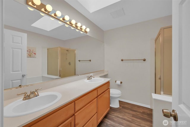 19168 110th Pl SE Unit 19168, Renton, WA 98055 - full bath with a skylight, a shower stall, double vanity, and wood finished floors