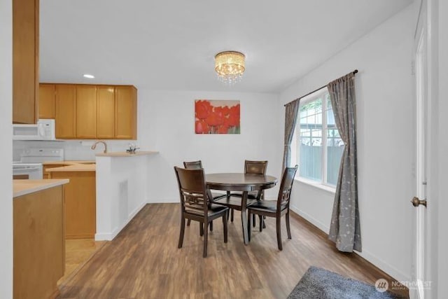 19168 110th Pl SE Unit 19168, Renton, WA 98055 - dining space with wood finished floors and a chandelier