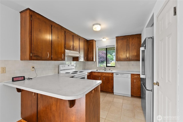802 39th Pl, Bellingham, WA 98229 - kitchen featuring white appliances, under cabinet range hood, a peninsula, and light countertops
