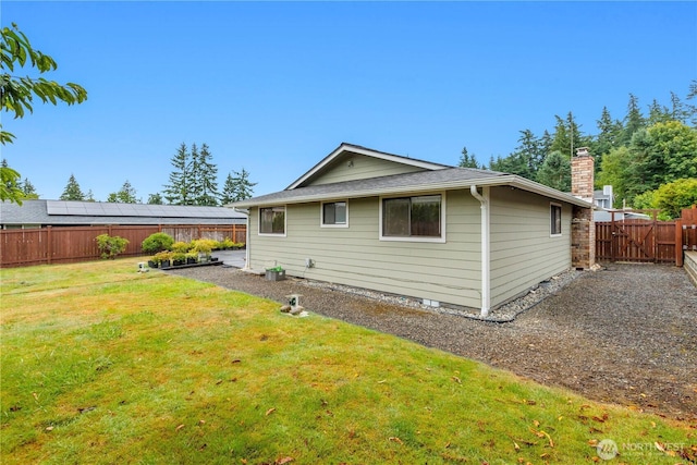 802 39th Pl, Bellingham, WA 98229 - back of house with a fenced backyard, a chimney, roof with shingles, and a gate