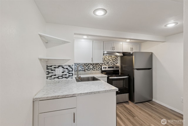 7519 Atchinson Dr SE, Olympia, WA 98513 - kitchen with appliances with stainless steel finishes, open shelves, under cabinet range hood, decorative backsplash, and light wood-type flooring