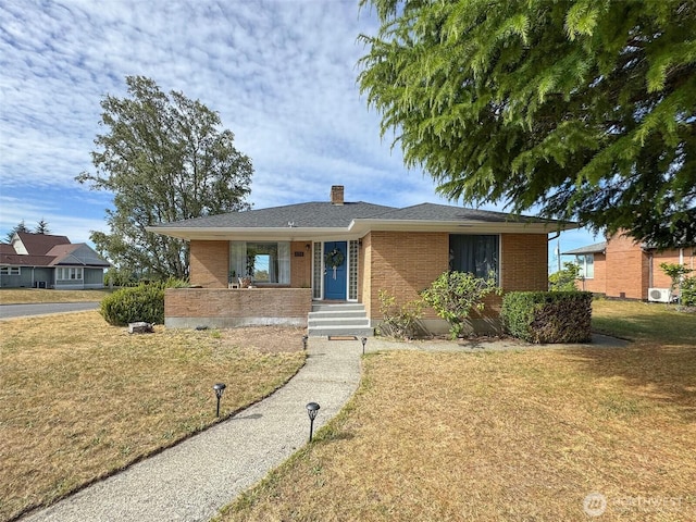 101 E Whidby Ave, Port Angeles, WA 98362 - view of front of home featuring a front lawn, a chimney, and brick siding