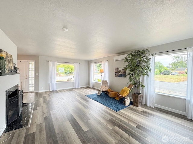 101 E Whidby Ave, Port Angeles, WA 98362 - sitting room featuring a textured ceiling, wood finished floors, and a high end fireplace