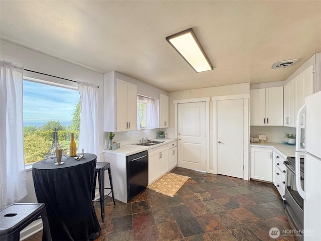 101 E Whidby Ave, Port Angeles, WA 98362 - kitchen featuring black dishwasher, dark stone finish floors, stainless steel range with electric stovetop, and white cabinetry