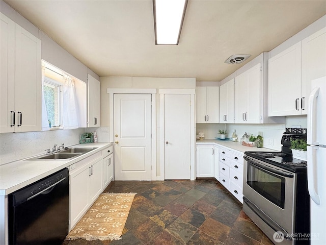 101 E Whidby Ave, Port Angeles, WA 98362 - kitchen featuring dishwasher, electric stove, dark stone finish floors, freestanding refrigerator, and light countertops