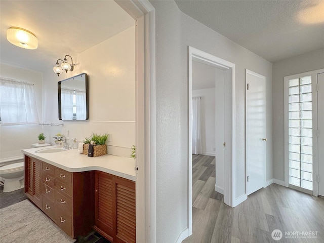 101 E Whidby Ave, Port Angeles, WA 98362 - bathroom featuring vanity, wood finished floors, and a textured ceiling