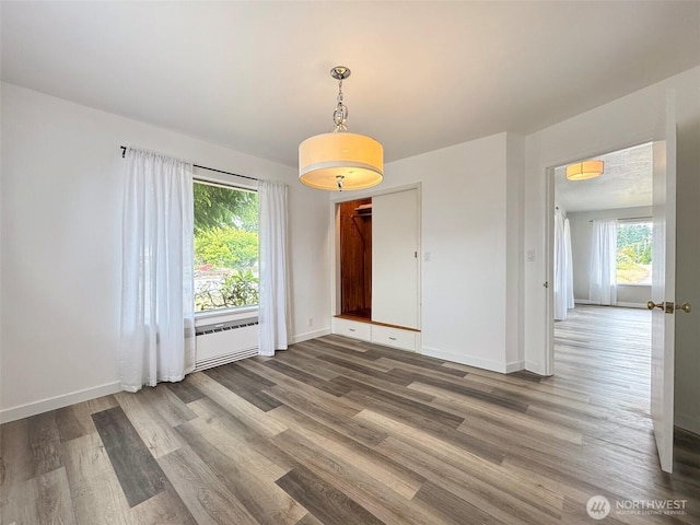101 E Whidby Ave, Port Angeles, WA 98362 - unfurnished dining area with wood finished floors and baseboards