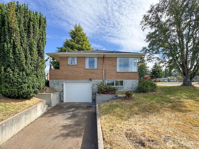 101 E Whidby Ave, Port Angeles, WA 98362 - view of side of property featuring driveway, an attached garage, brick siding, and a lawn