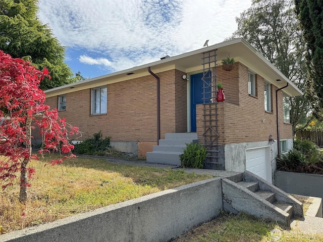 101 E Whidby Ave, Port Angeles, WA 98362 - view of front of property featuring a garage and brick siding
