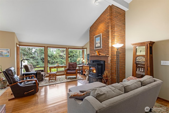 190 Bluffs Dr Unit 1, Port Townsend, WA 98368 - living room featuring a wood stove, high vaulted ceiling, and wood finished floors