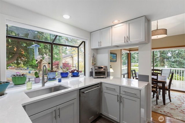 190 Bluffs Dr Unit 1, Port Townsend, WA 98368 - kitchen featuring stainless steel dishwasher, light countertops, gray cabinetry, recessed lighting, and a peninsula
