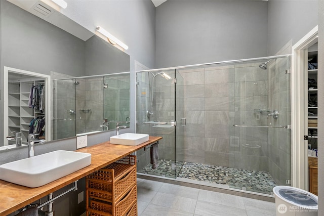 190 Bluffs Dr Unit 1, Port Townsend, WA 98368 - bathroom with a spacious closet, double vanity, and a shower stall