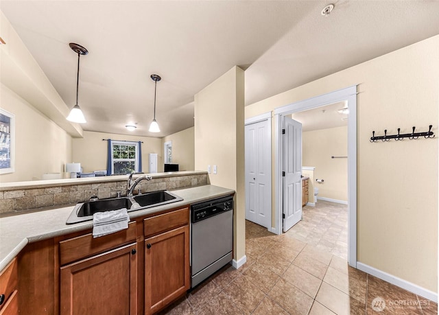 690 32nd St Unit B210, Bellingham, WA 98225 - kitchen featuring stainless steel dishwasher, brown cabinets, hanging light fixtures, light countertops, and light tile patterned floors